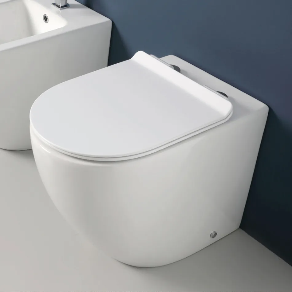 Toilettes Aralia blanches en céramique, à montage sur pied et à effet cyclonique, avec siège à fermeture amortie Viadurini