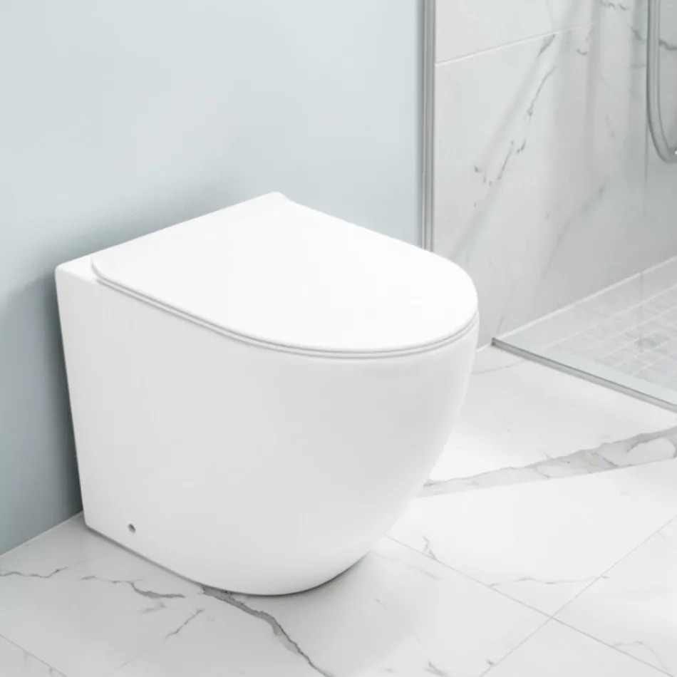 Toilettes Aralia blanches en céramique, à montage sur pied et à effet cyclonique, avec siège à fermeture amortie Viadurini