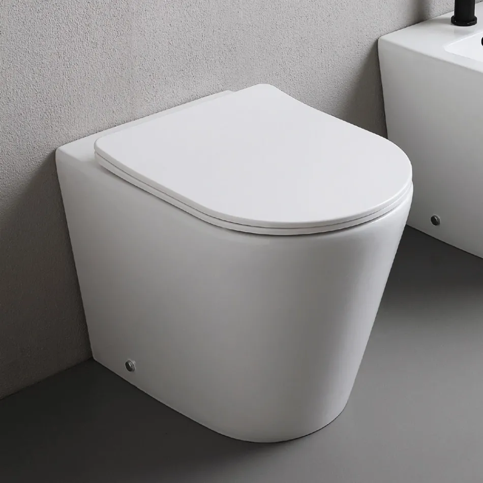 Toilettes sur pied avec abattant fin à fermeture ralentie en céramique blanche - Salice Viadurini