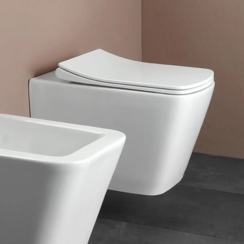 WC suspendu avec abattant en céramique à fermeture ralentie, design moderne - Giunco Viadurini