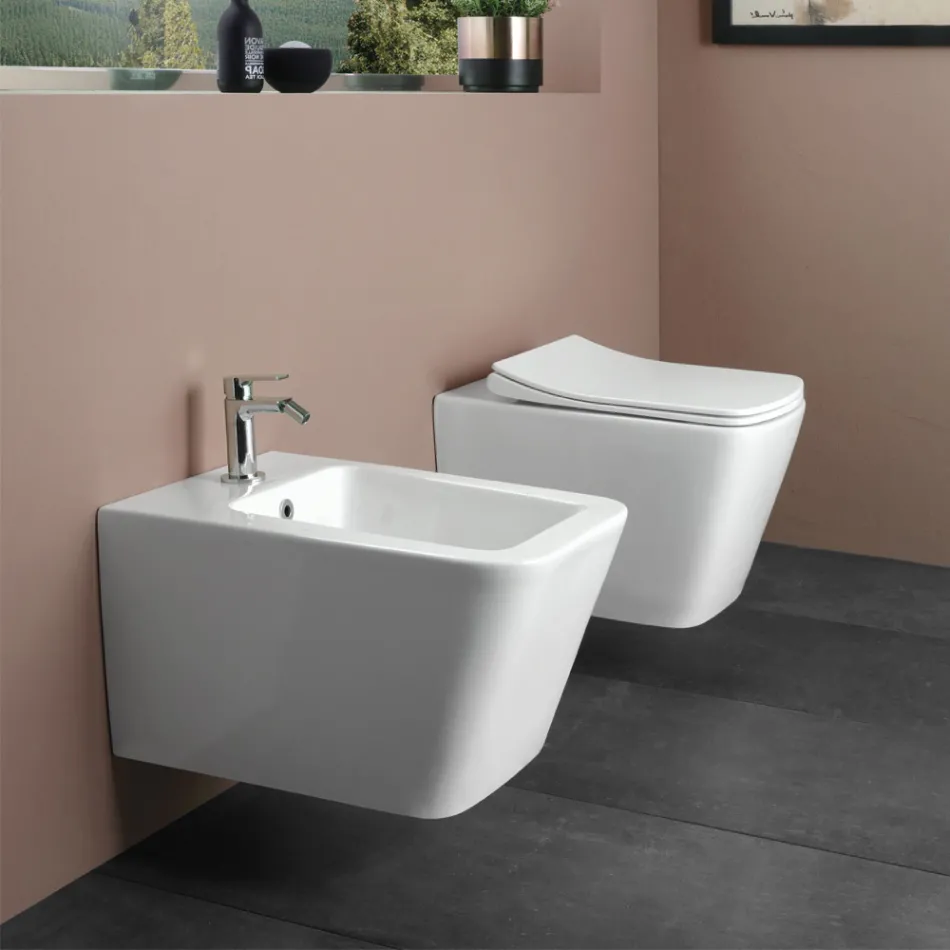 WC suspendu avec abattant en céramique à fermeture ralentie, design moderne - Giunco Viadurini